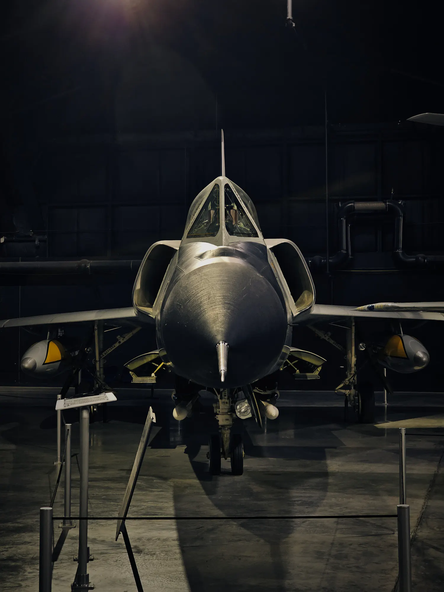 Convair F-106 Delta Dart photographed head-on in a dark museum hangar